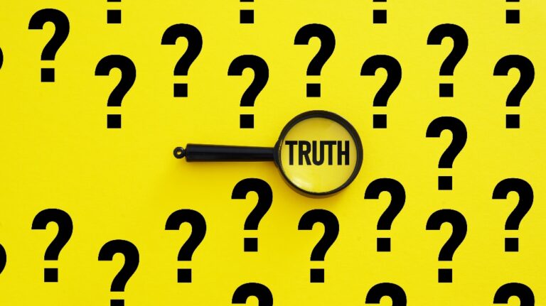 question marks with the word truth in a magnifying glass