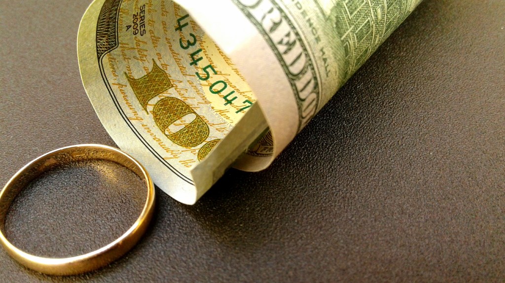 dollar bill and wedding ring