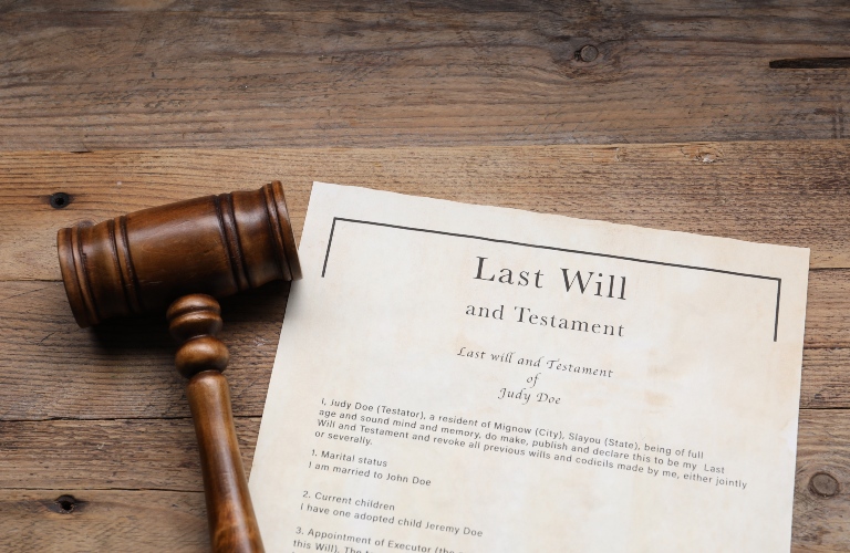 Last Will and Testament with gavel on wooden table
