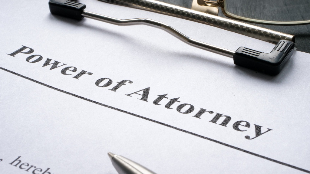 Clipboard with Power of attorney and pen for signing