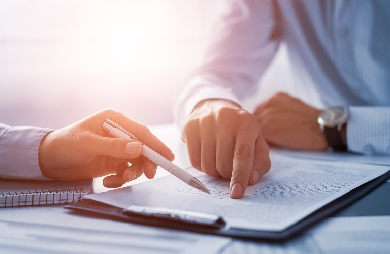 lawyer is showing client where to sign