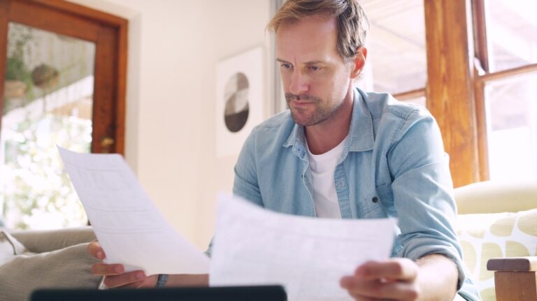 man is looking through documents