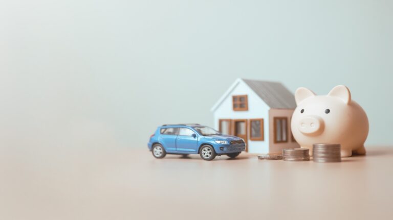 toy house car and piggybank with coins