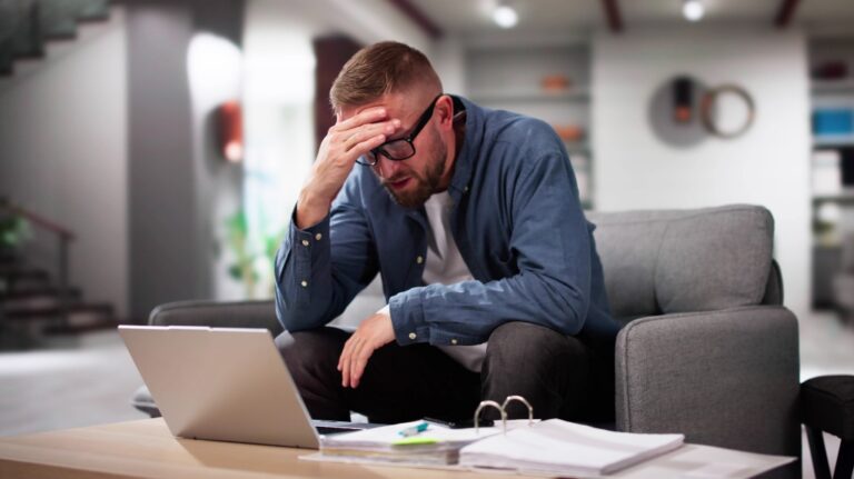 Depressed man is reviewing his bills
