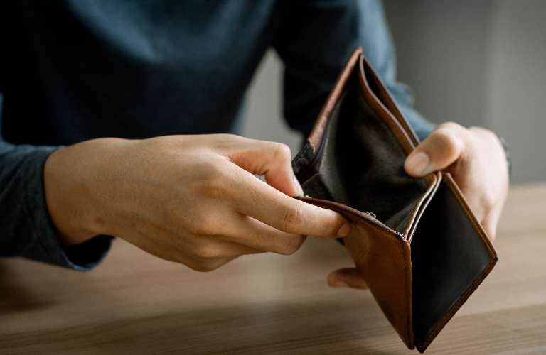Man is opening empty wallet